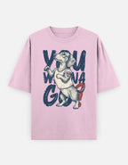 A light pink short-sleeve t-shirt with a graphic print of a dachshund wearing a white tank top, surrounded by the text 'YOU WONA GO'.