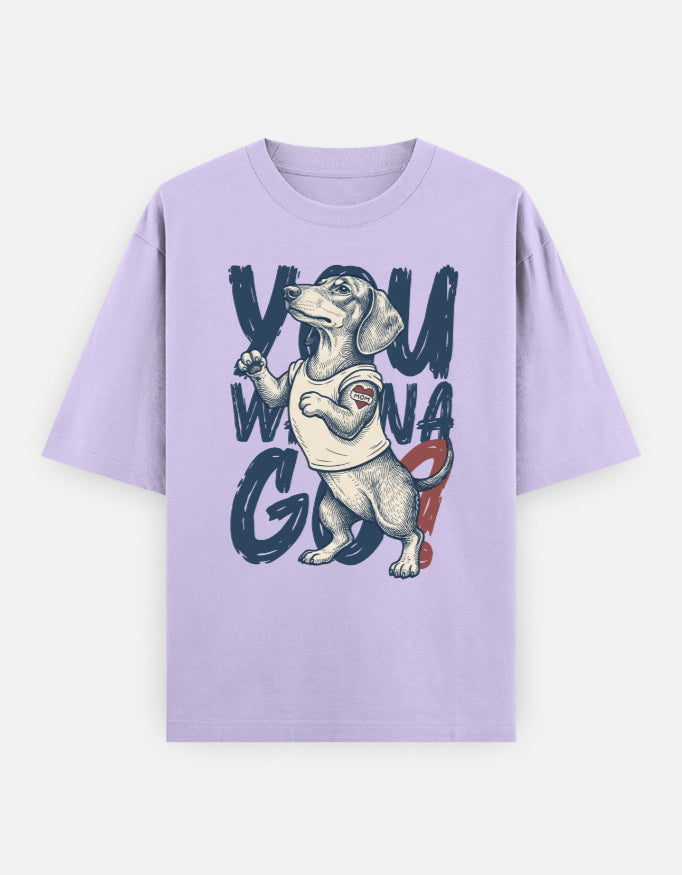 A light purple short-sleeve t-shirt with a graphic of a dachshund wearing a white tank top and red shorts, set against the text 'YOU WIN A GO'.